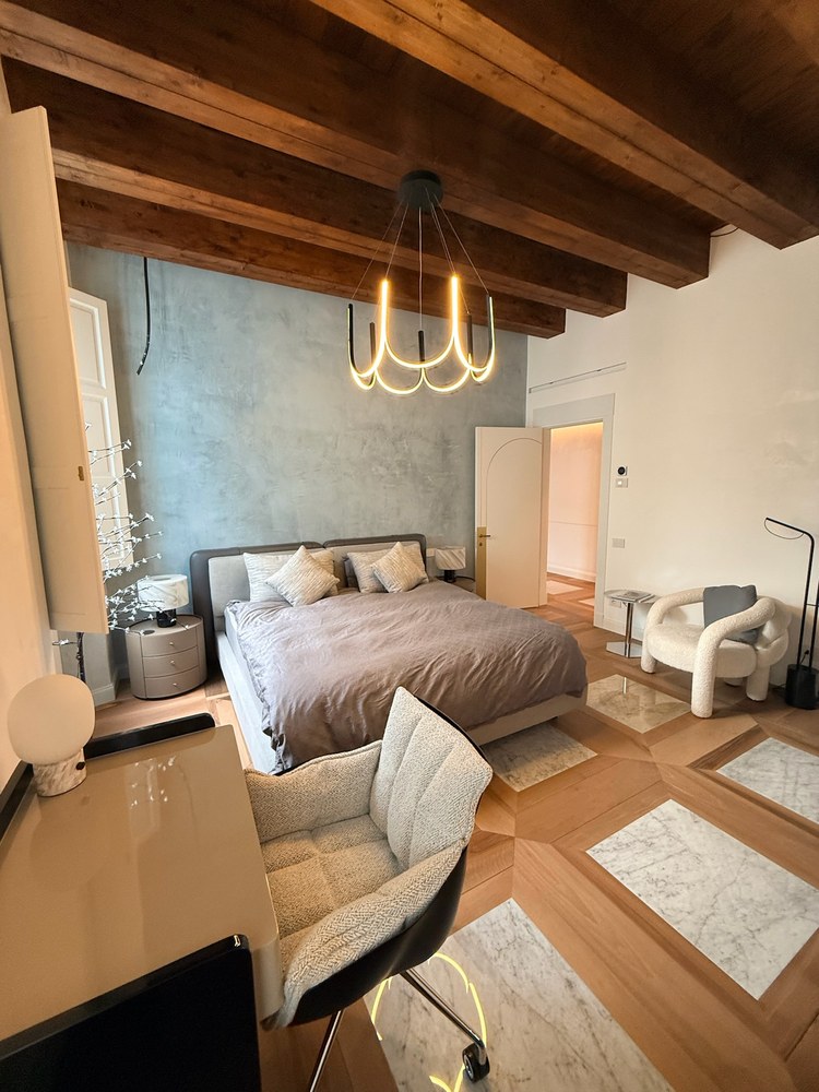 Second bedroom — chandelier, king bed