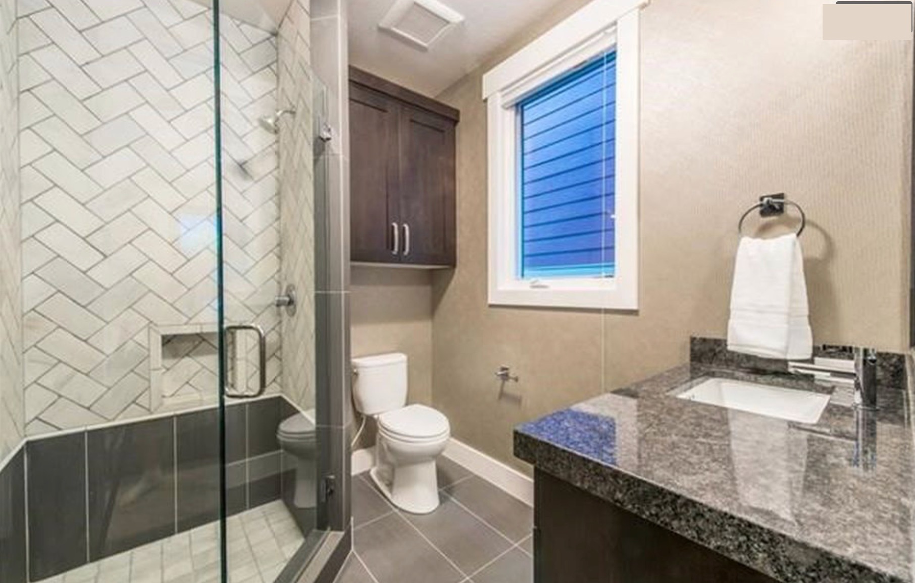 Guest bath — herringbone subway tile shower, granite vanity