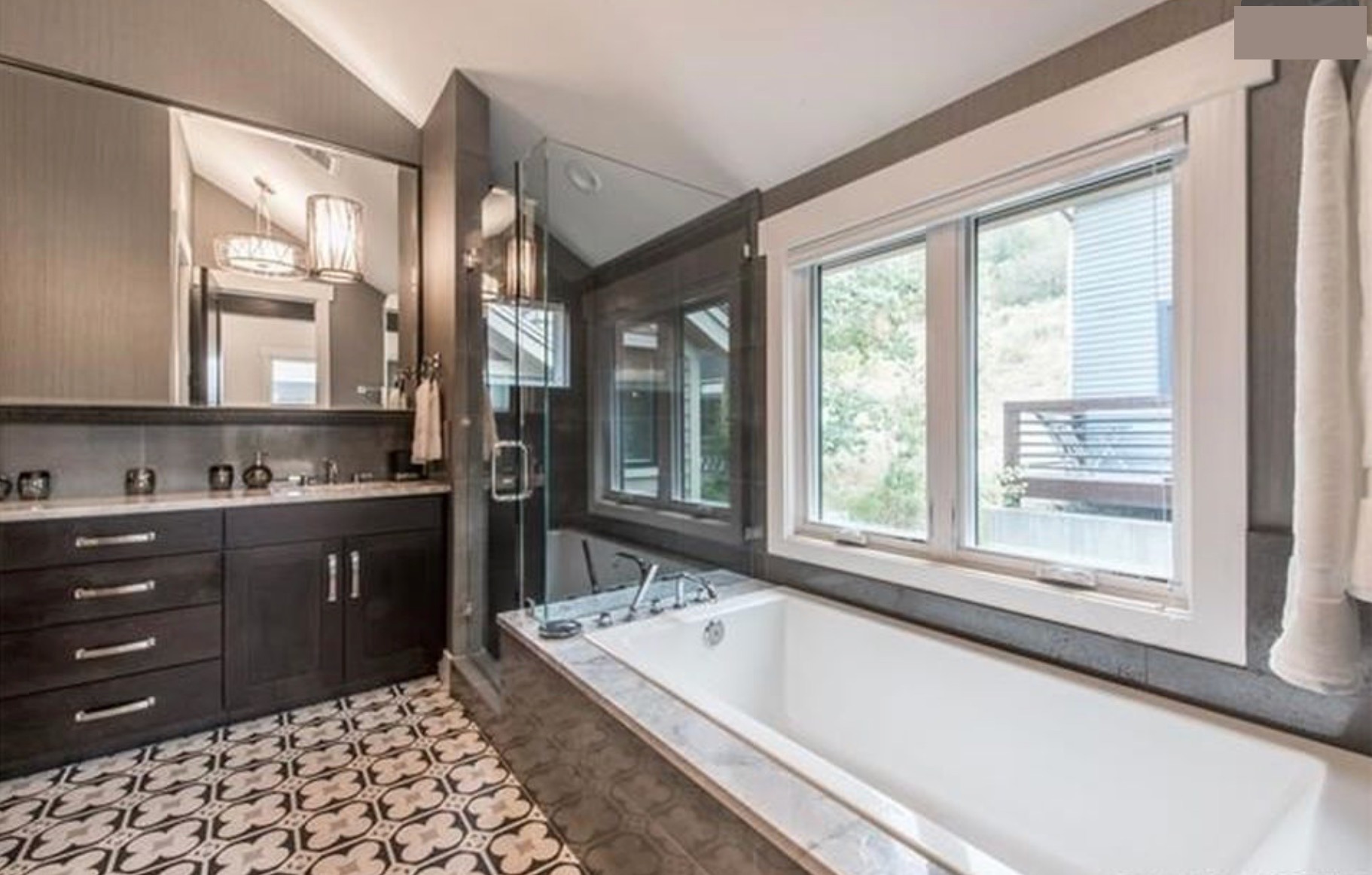 Master bath — deep soaking tub beneath the mountain-view window