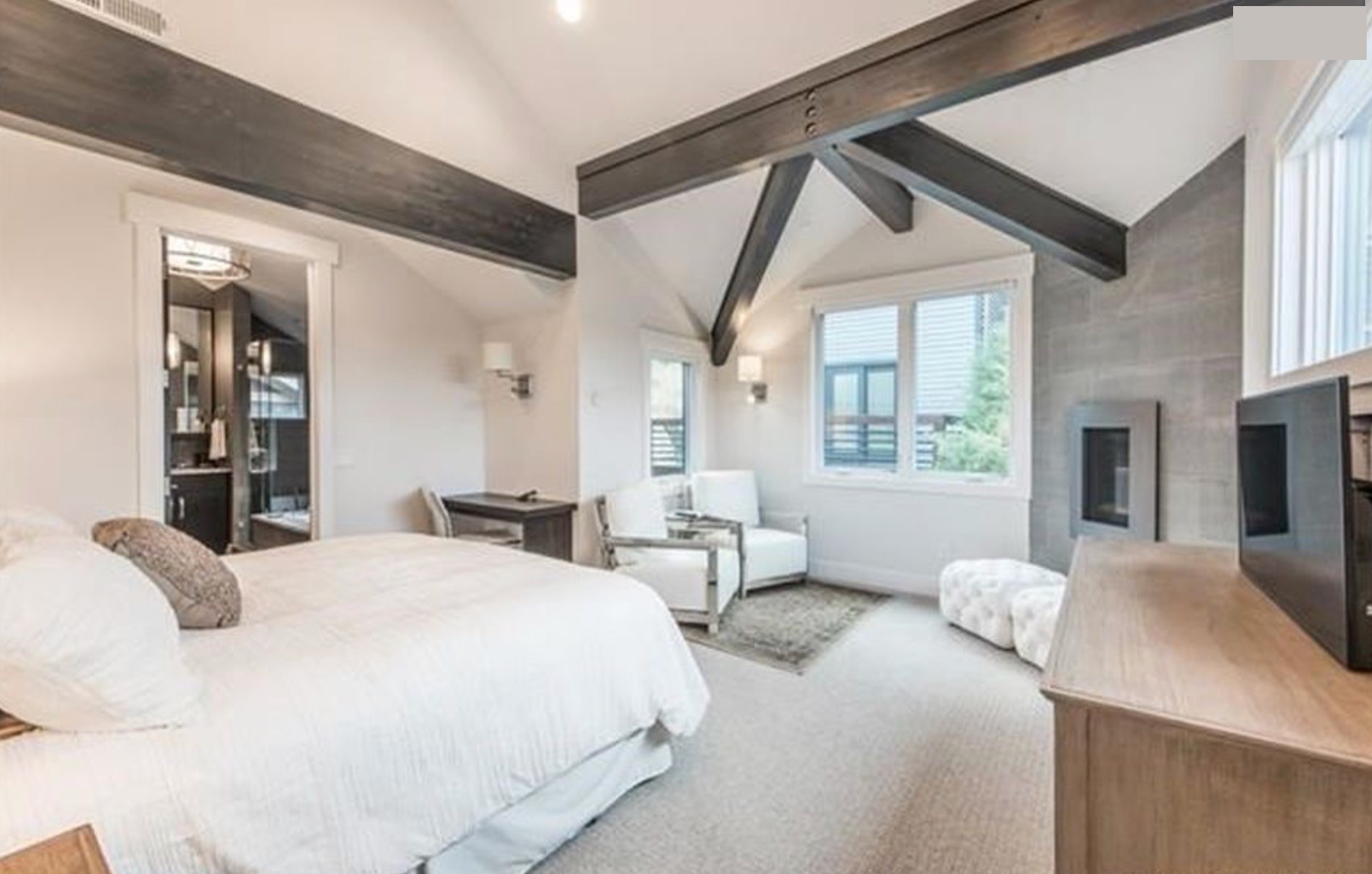 Master bedroom — exposed beams, vaulted ceiling, sitting area, fireplace