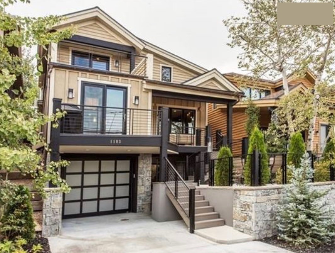 Old Town Estate exterior — the front porch, balcony, and stone-walled entry