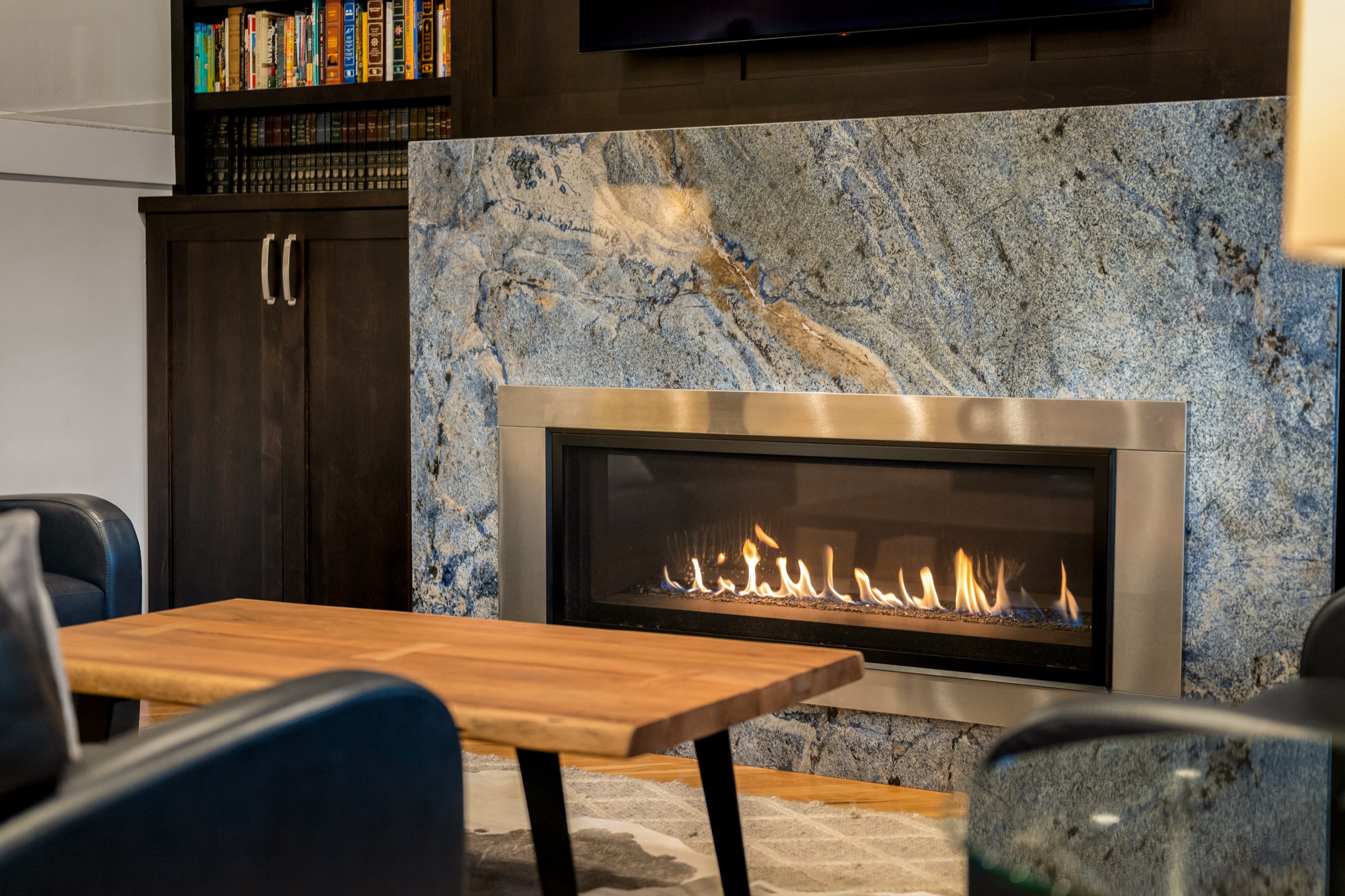 Open living room and kitchen with marble fireplace surround