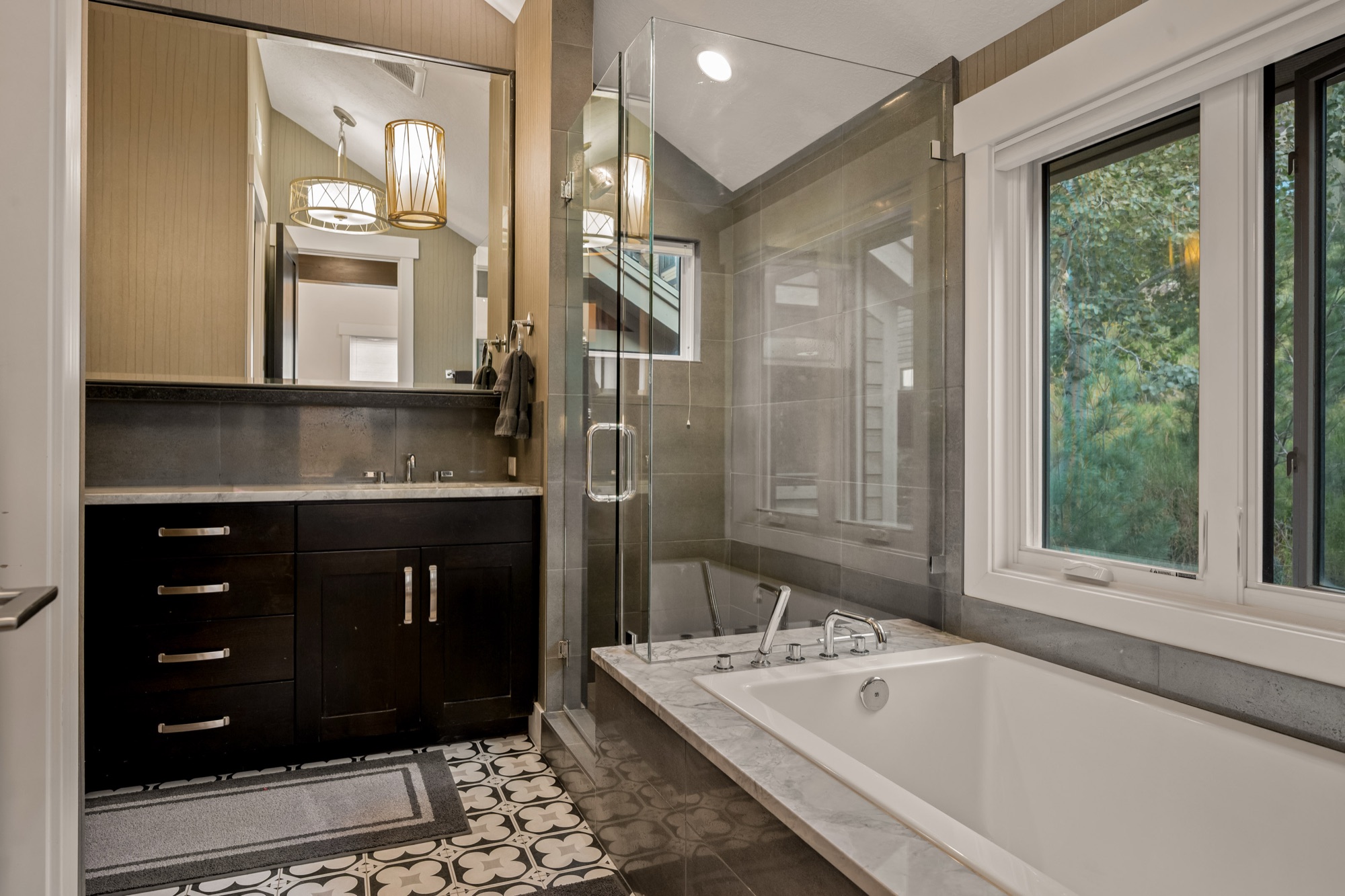 Master bath — deep soaking tub beneath the mountain-view window