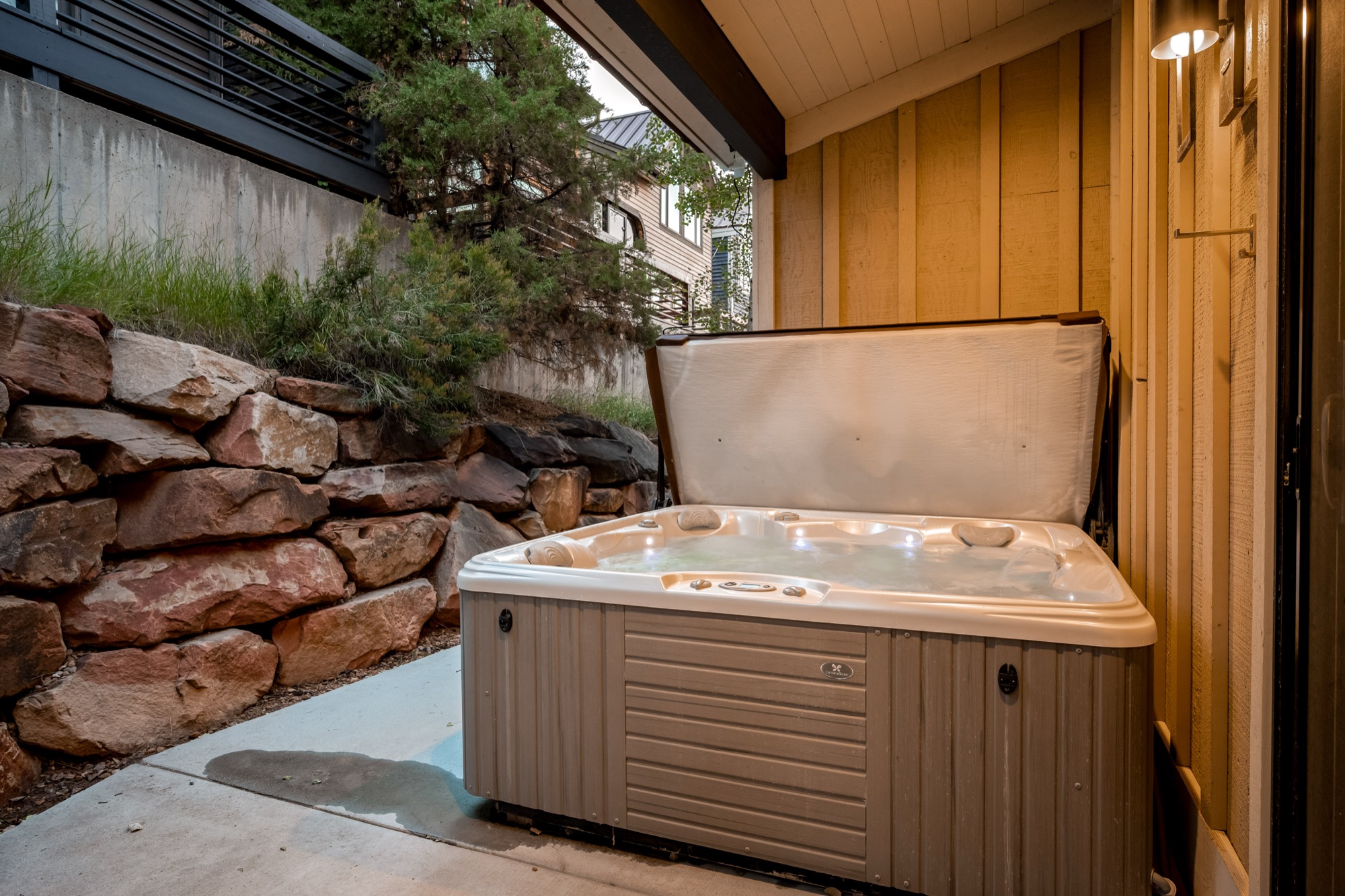 Private hot tub beside the stone wall