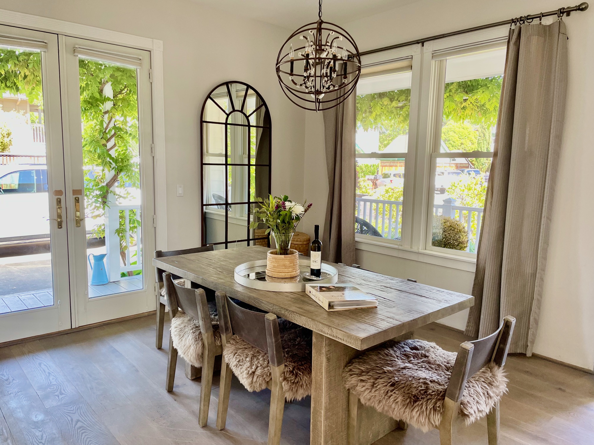 Dining room — French doors, wisteria, sheepskin chairs