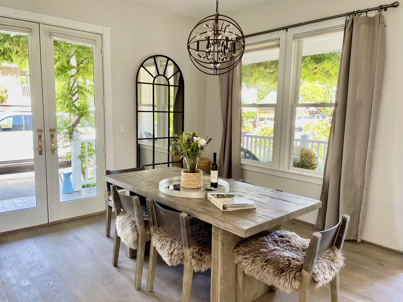 Dining room — French doors, wisteria, sheepskin chairs